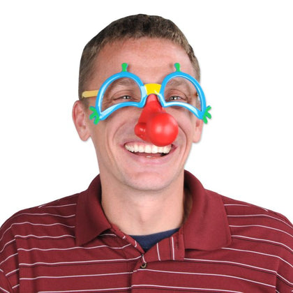 Person wearing a clown nose and glasses with a red background