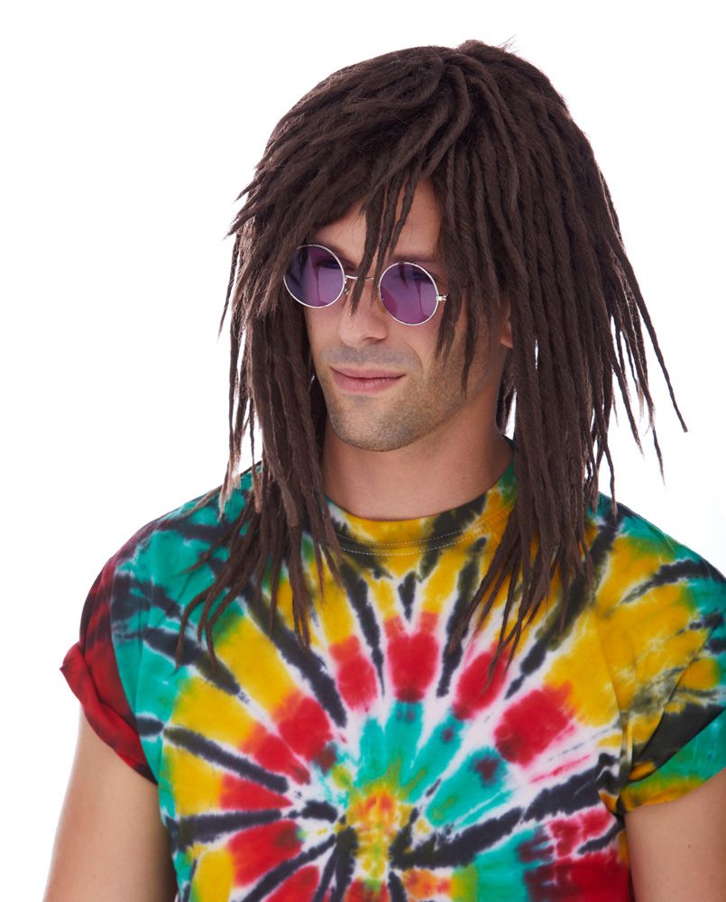 Person wearing a colorful tie-dye shirt and dreadlocks with sunglasses on a white background