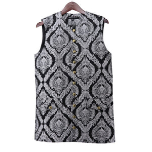 Black and white patterned sleeveless top with gold buttons on a hanger against a white background