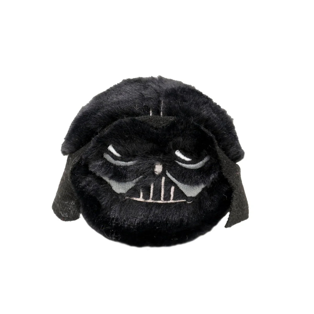 Plush toy resembling a character with a dark helmet on a white background