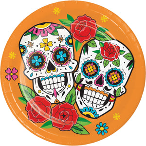 Decorative paper plate with colorful sugar skull design and flowers on an orange background