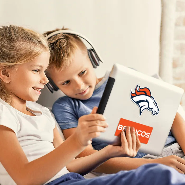 Two children using a tablet with a Broncos logo on a light-colored background