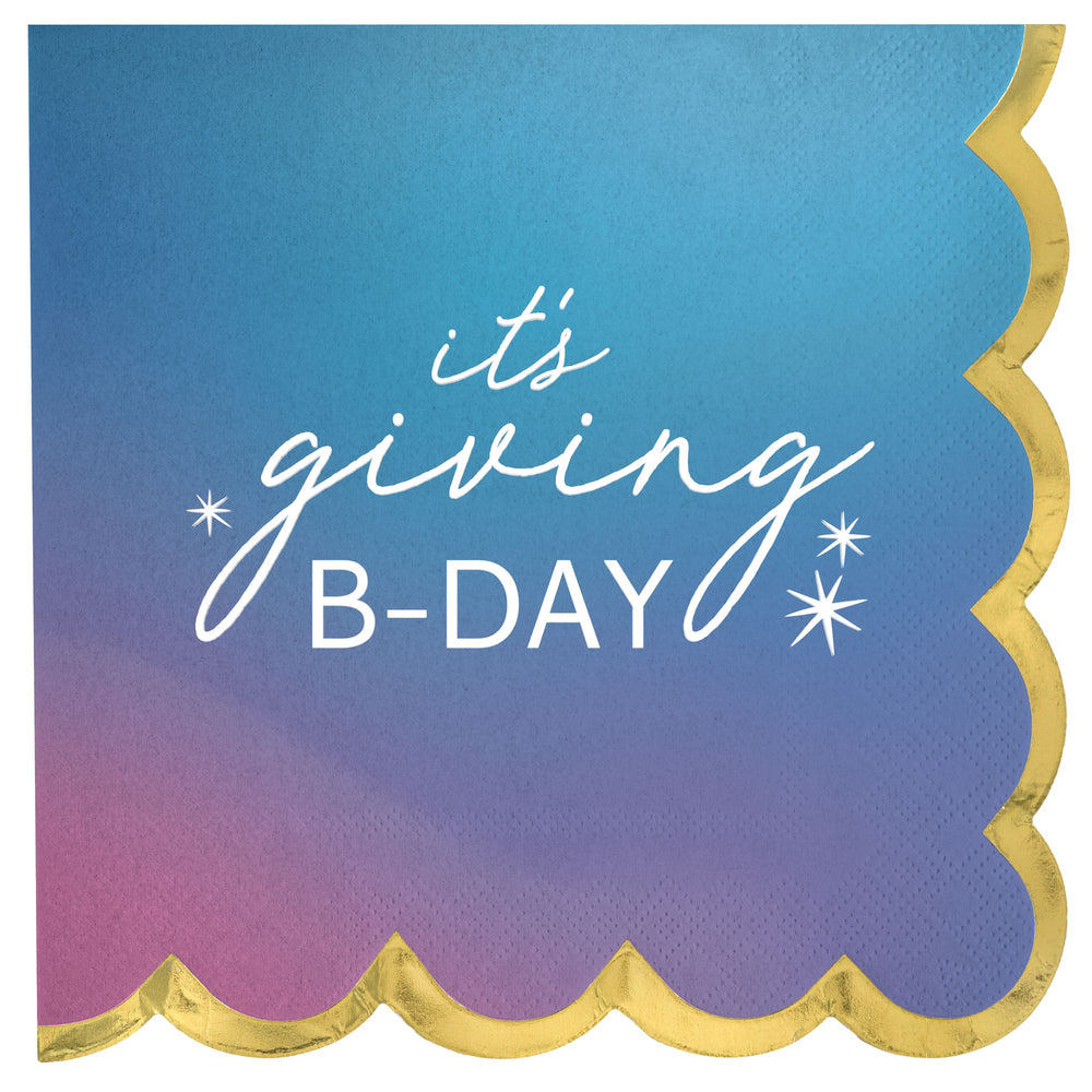 Napkin with 'it's giving B-DAY' text on a gradient blue and pink background with gold trim.