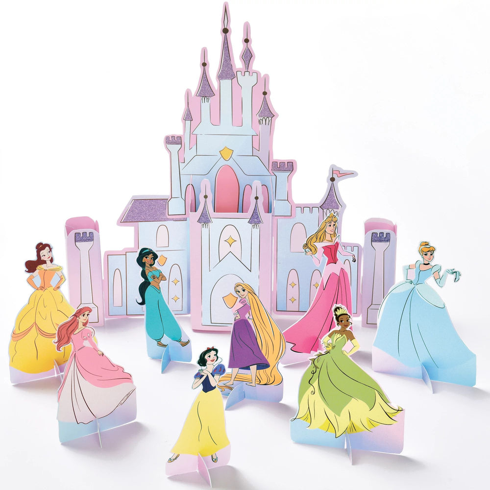 Set of Disney princess figurines in front of a castle model on a white background
