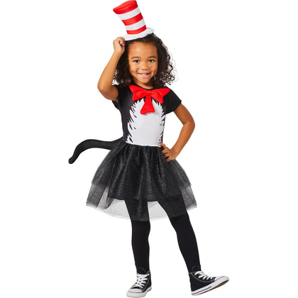 Child wearing a black and white costume with a red bow tie and cat ears on a white background