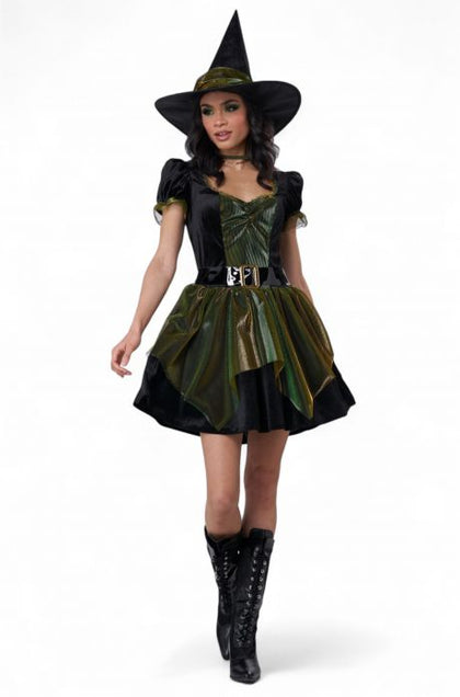 Woman wearing a witch costume with a black hat, dress, and boots on a white background