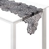 Black lace spider web table runner on a white table