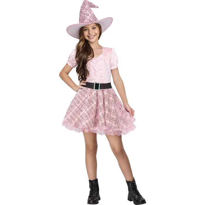 A young girl modeling a pink witch costume consisting of a short-sleeve top, pleated skirt, a black belt, and a matching pointed witch hat, set against a plain white background.