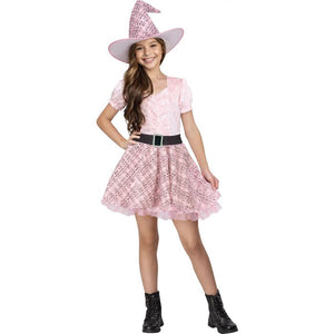 A young girl modeling a pink witch costume consisting of a short-sleeve top, pleated skirt, a black belt, and a matching pointed witch hat, set against a plain white background.