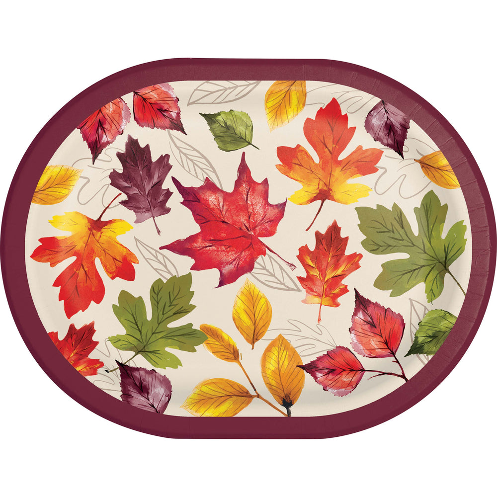 An oval paper plate featuring a colorful autumn leaf pattern on a cream background with a dark burgundy rim.
