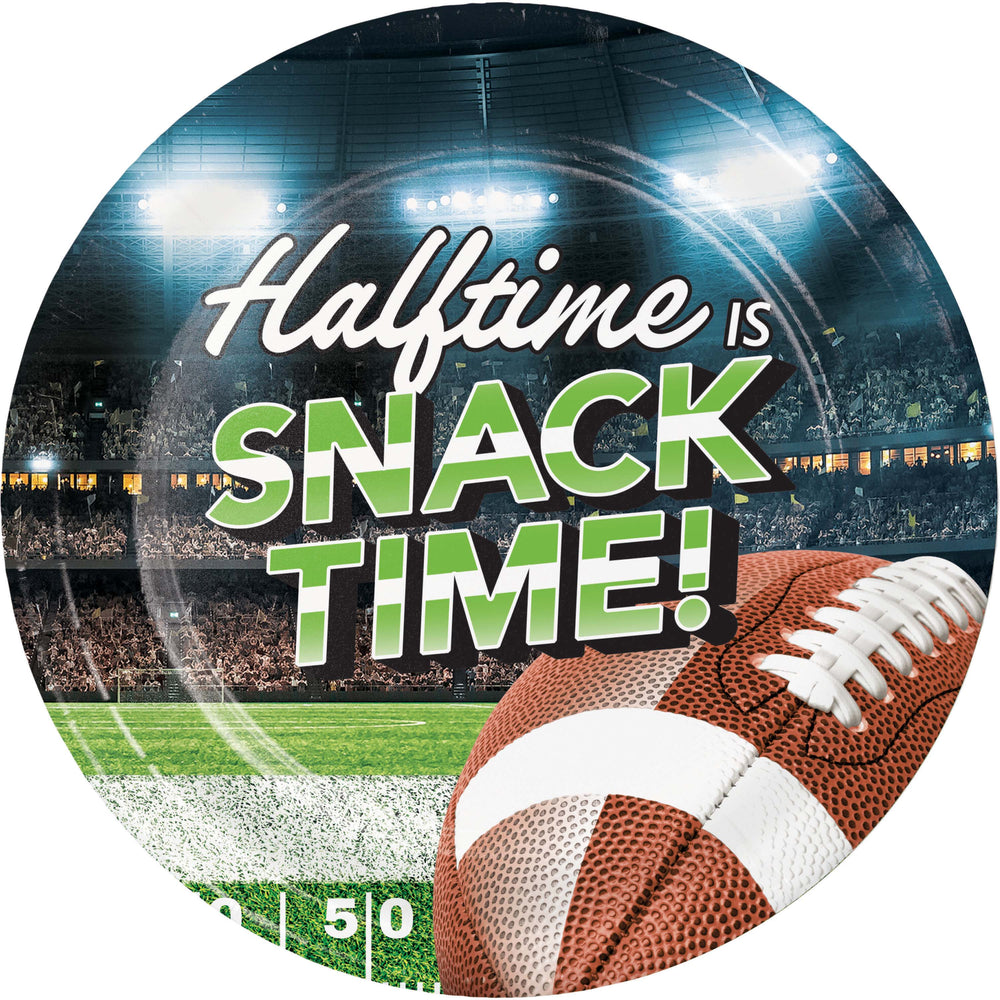 A round printed plate or sign featuring a football stadium scene with the text 'Halftime IS SNACK TIME!' and a football in the foreground.