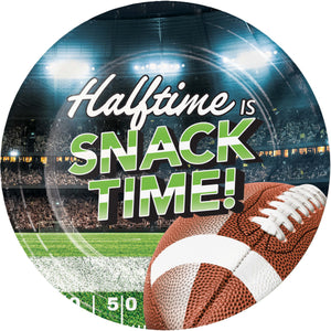 A round printed plate or sign featuring a football stadium scene with the text 'Halftime IS SNACK TIME!' and a football in the foreground.