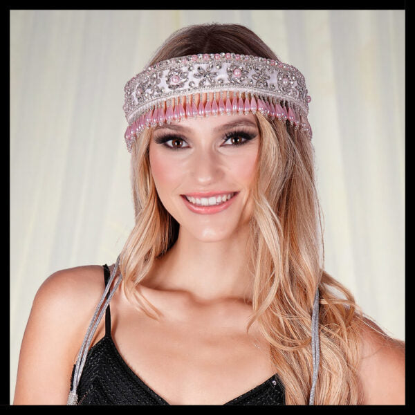 Woman wearing a decorative headband with a plain background