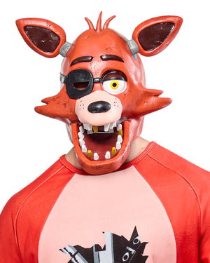 Person wearing a red mask with large ears and a cartoonish design on a white background