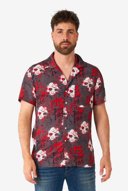 Man wearing a red and black patterned shirt with skulls on a white background