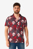 Man wearing a red and black patterned shirt with skulls on a white background