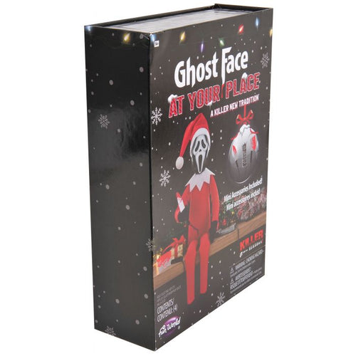 A boxed novelty item labeled 'Ghost Face AT YOUR PLACE' on a plain white background. The package is predominantly black with red, white, and small multicolor holiday light graphics, and shows an illustrated Ghost Face figure in a Santa outfit and a Santa sack.