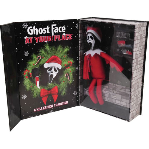 A Ghost Face 'At Your Place' themed gift box set, featuring a plush Ghost Face doll dressed as an elf in a red suit and Santa hat inside a clear window, with the illustrated cover and gift box packaging displayed on a white background.