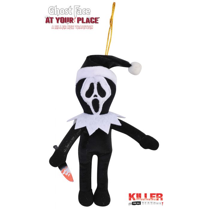 A Ghost Face plush ornament from the movie 'At Your Place' wearing a Santa hat and holding a knife, on a white background with movie text overlays.