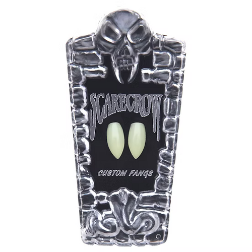 A coffin-shaped display card for 'Scarecrow' custom vampire fangs, featuring a skull and stone border design with two glowing pale green fangs in the center, on a white background.