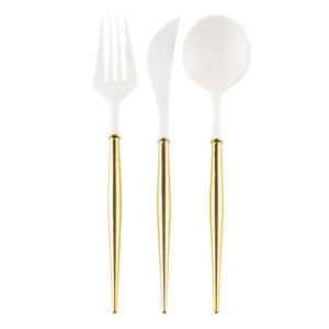 Set of white cutlery with gold handles on a white background