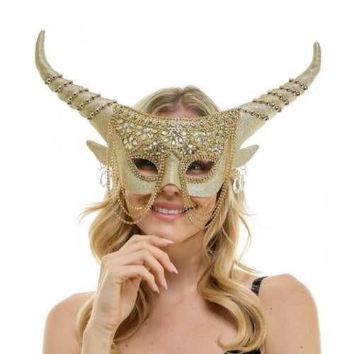 A woman wearing a decorative gold horned masquerade mask with rhinestone embellishments and long curved horns, photographed against a plain white background.