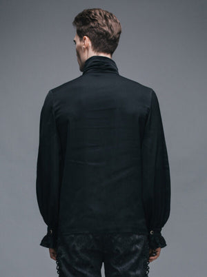 Man wearing a black shirt with ruffled cuffs and hem against a gray background