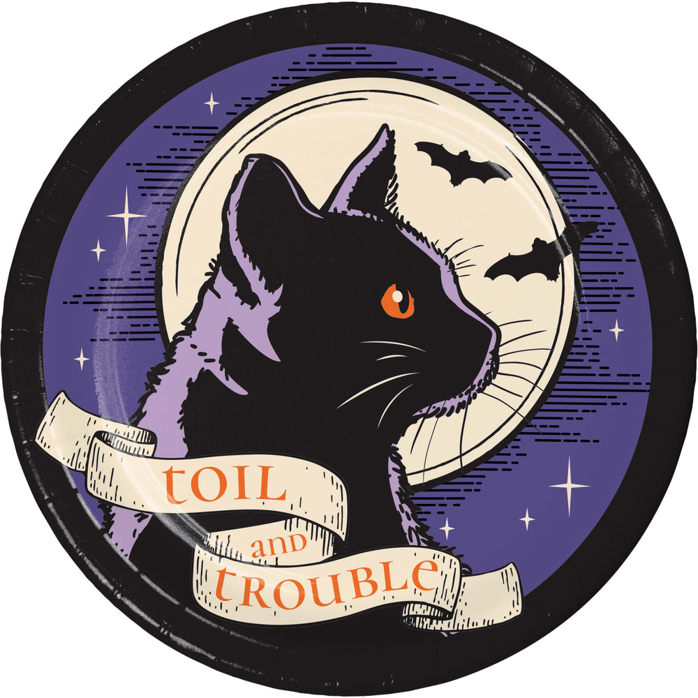 A circular vintage-style illustration featuring a black cat in profile with one orange eye, set against a purple night sky with bats, stars, and a cream moon. A cream banner across the bottom reads 'TOIL and TROUBLE'.