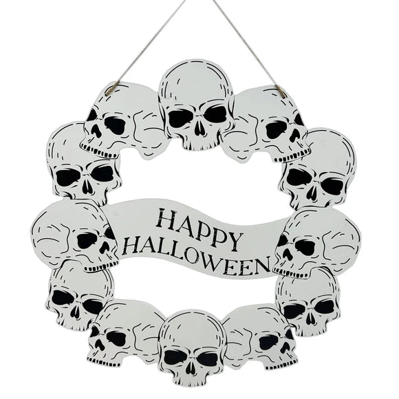 A circular Halloween wall hanging decorated with multiple white skulls and a banner in the center that reads 'HAPPY HALLOWEEN' in black lettering, suspended by a thin string against a plain white background.