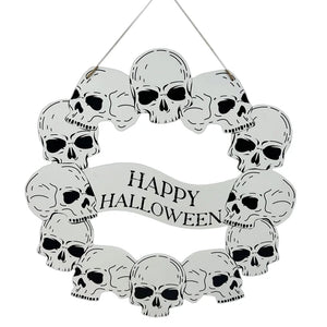 A circular Halloween wall hanging decorated with multiple white skulls and a banner in the center that reads 'HAPPY HALLOWEEN' in black lettering, suspended by a thin string against a plain white background.