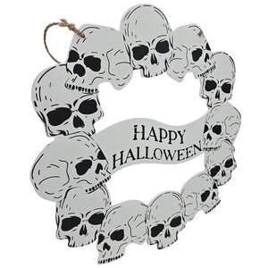 A circular Halloween wreath made of stacked skull cutouts with a hanging loop at the top and a banner reading 'Happy Halloween' in black text on a white background.