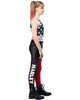 Person wearing a black and white star-patterned top and red and black leggings with 'Harley' branding.