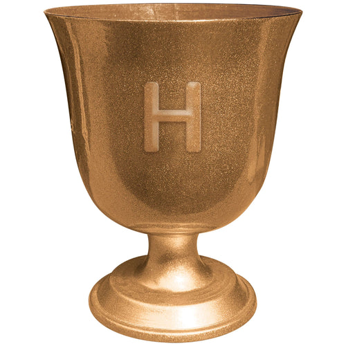 Bronze-colored urn with a letter 'H' on a white background
