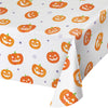 Halloween-themed tablecloth with orange jack-o'-lanterns on a white background