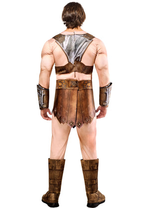 Person wearing a detailed warrior costume with armor and boots on a white background
