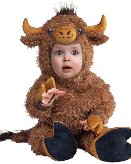 Child wearing a brown yak costume on a white background