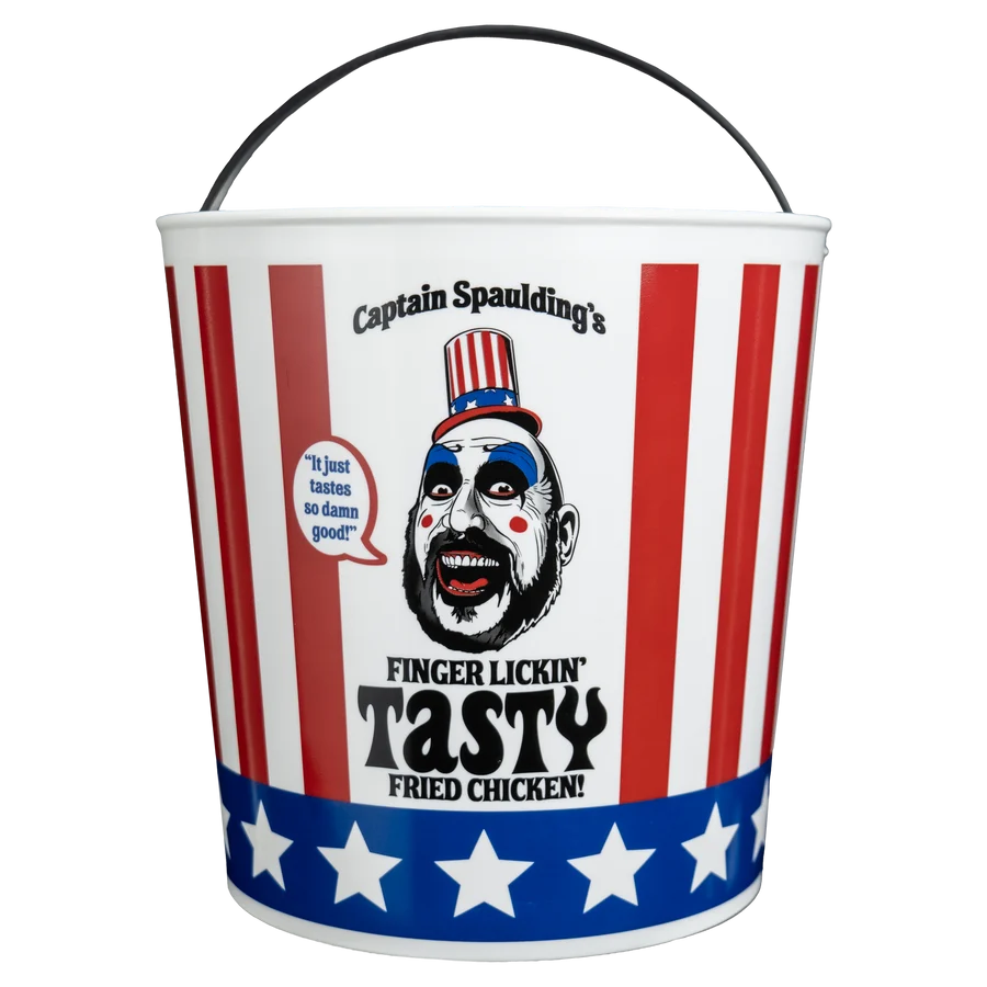 A novelty metal bucket with a black handle, featuring a patriotic red, white, and blue design with the text 'Captain Spaulding's Finger Lickin' Tasty Fried Chicken!' and a clown face illustration.