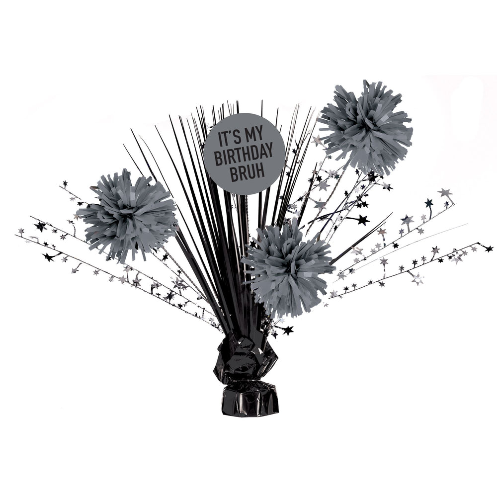 Decorative birthday centerpiece with gray pom-poms and a 'It's my birthday bruh' sign on a white background