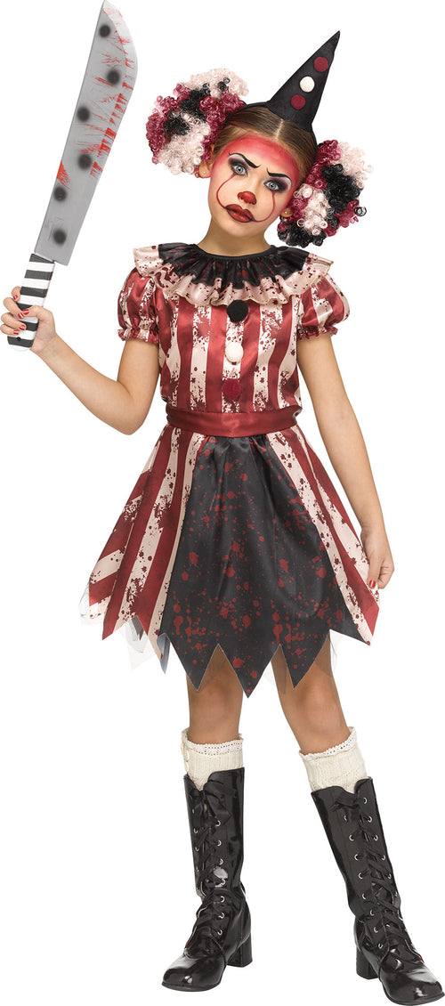 A child modeling a zombie clown costume against a plain white background, holding a toy cleaver prop. The costume features a red and white striped top, a blood-splattered black skirt, a black pointed hat, and black knee-high boots.