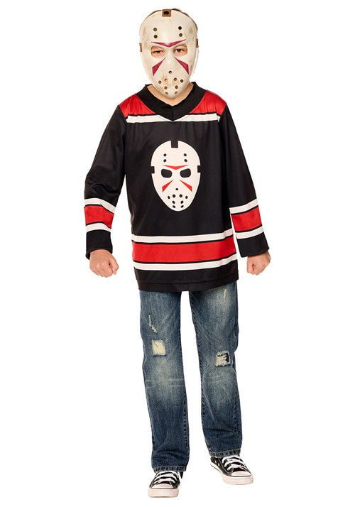 A child wearing a Jason Voorhees hockey costume, including a black jersey with red and white stripes, a hockey mask, and blue jeans, standing against a white background.