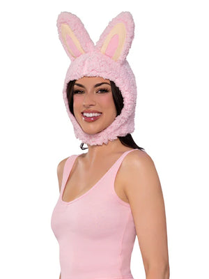Woman wearing a pink fluffy bunny hat on a white background