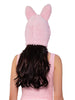 Person wearing a pink bunny hat with ears on a white background