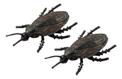 Two beetle figurines on a white background