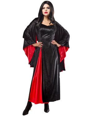 Woman wearing a black and red dress with a cape on a white background
