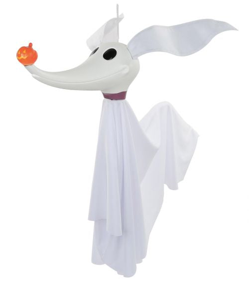 A white ghost dog Halloween decoration with a long snout, floppy ears, a draped white sheet body, and a small orange jack-o'-lantern in its mouth, shown on a plain white background.