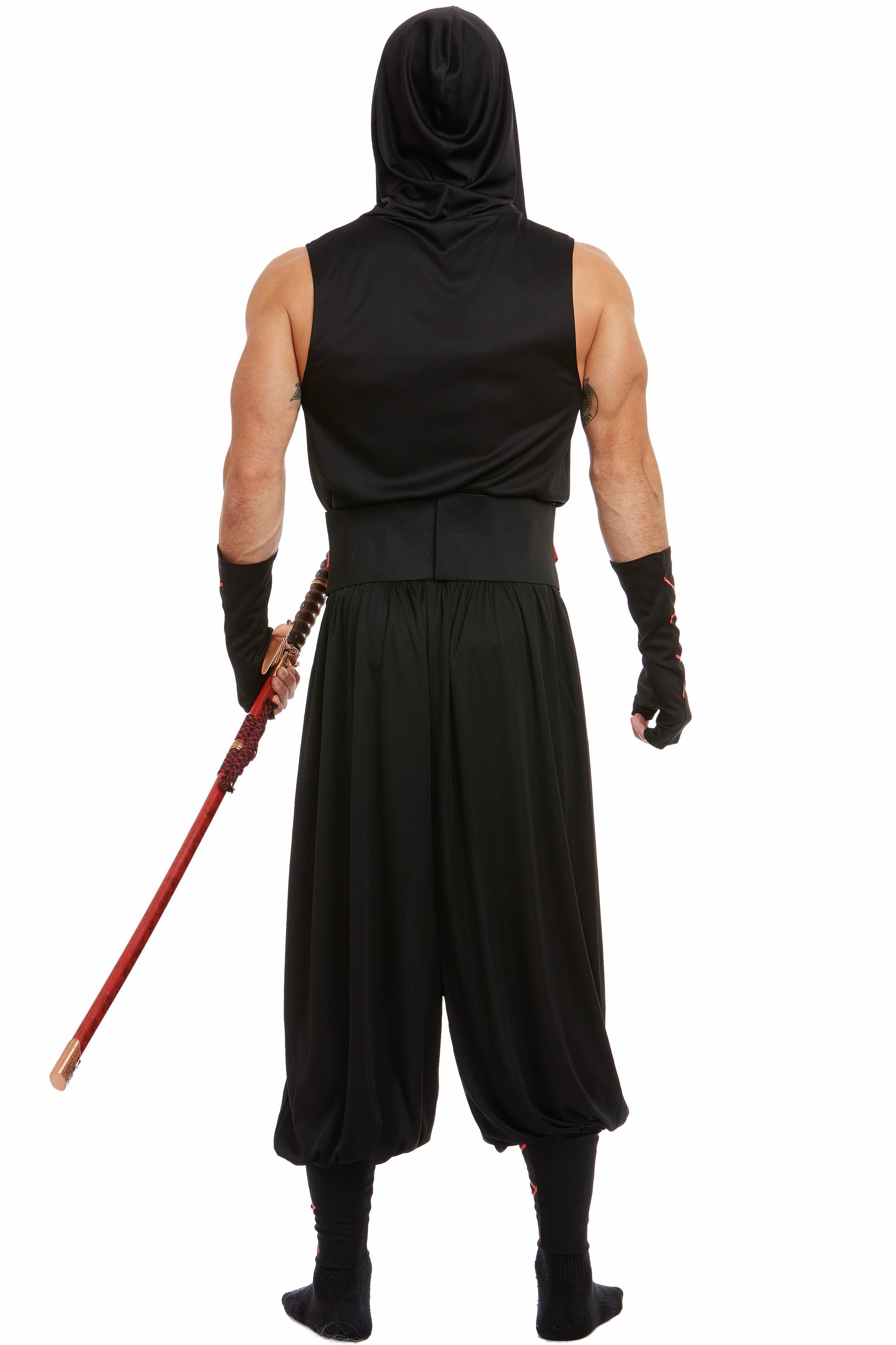 A man wearing a black ninja costume from the back, featuring a hooded top, loose harem-style pants, fingerless gloves, and black boots, holding a katana with a red handle against a plain white background.