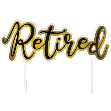 Cake topper with 'Retired' text in gold and black on a white background