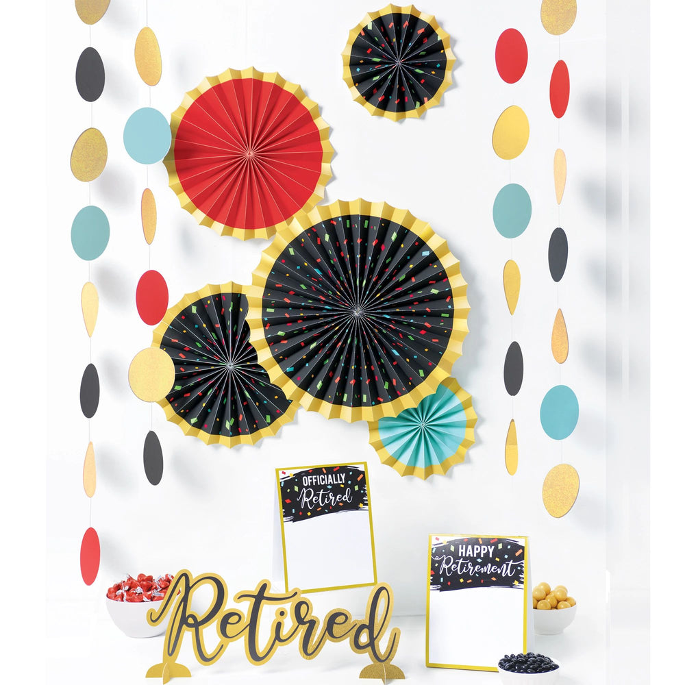 Decorative set with colorful paper fans and 'Retired' sign on a white background