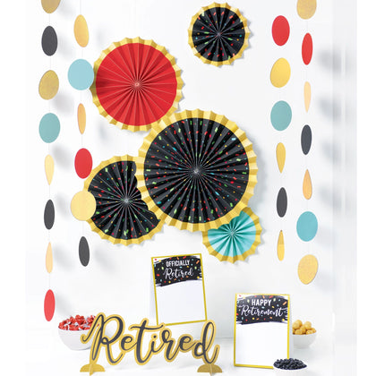 Decorative set with colorful paper fans and 'Retired' sign on a white background