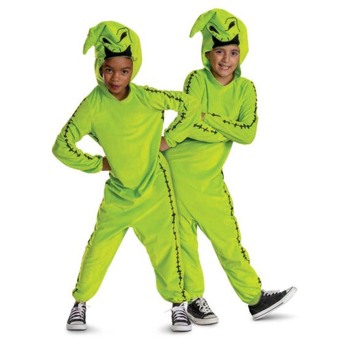 Two children wearing bright green costumes with hoodies and pants on a white background